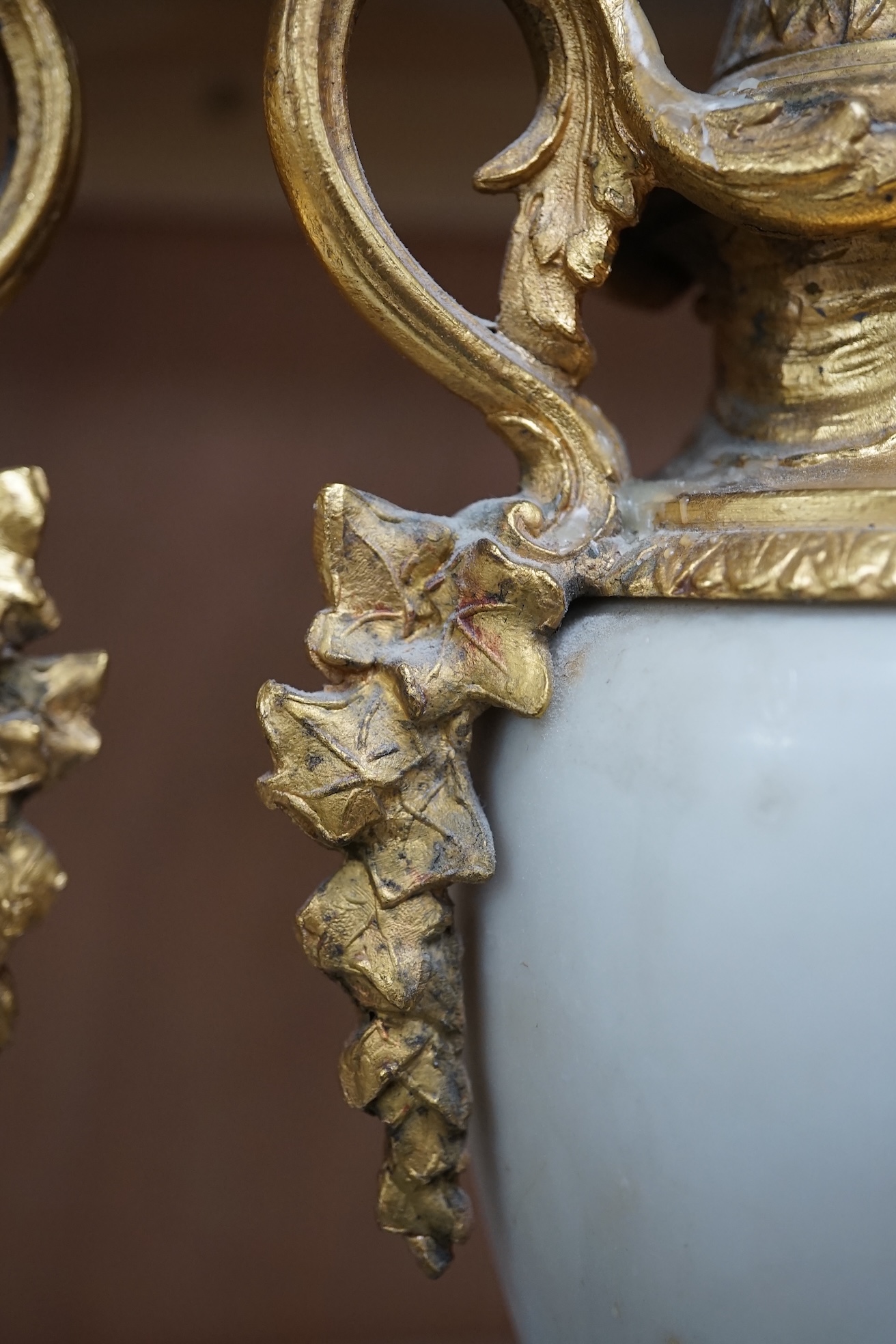 A pair of early 20th century white marble and gilt metal garnitures, 32cm. Condition - worn